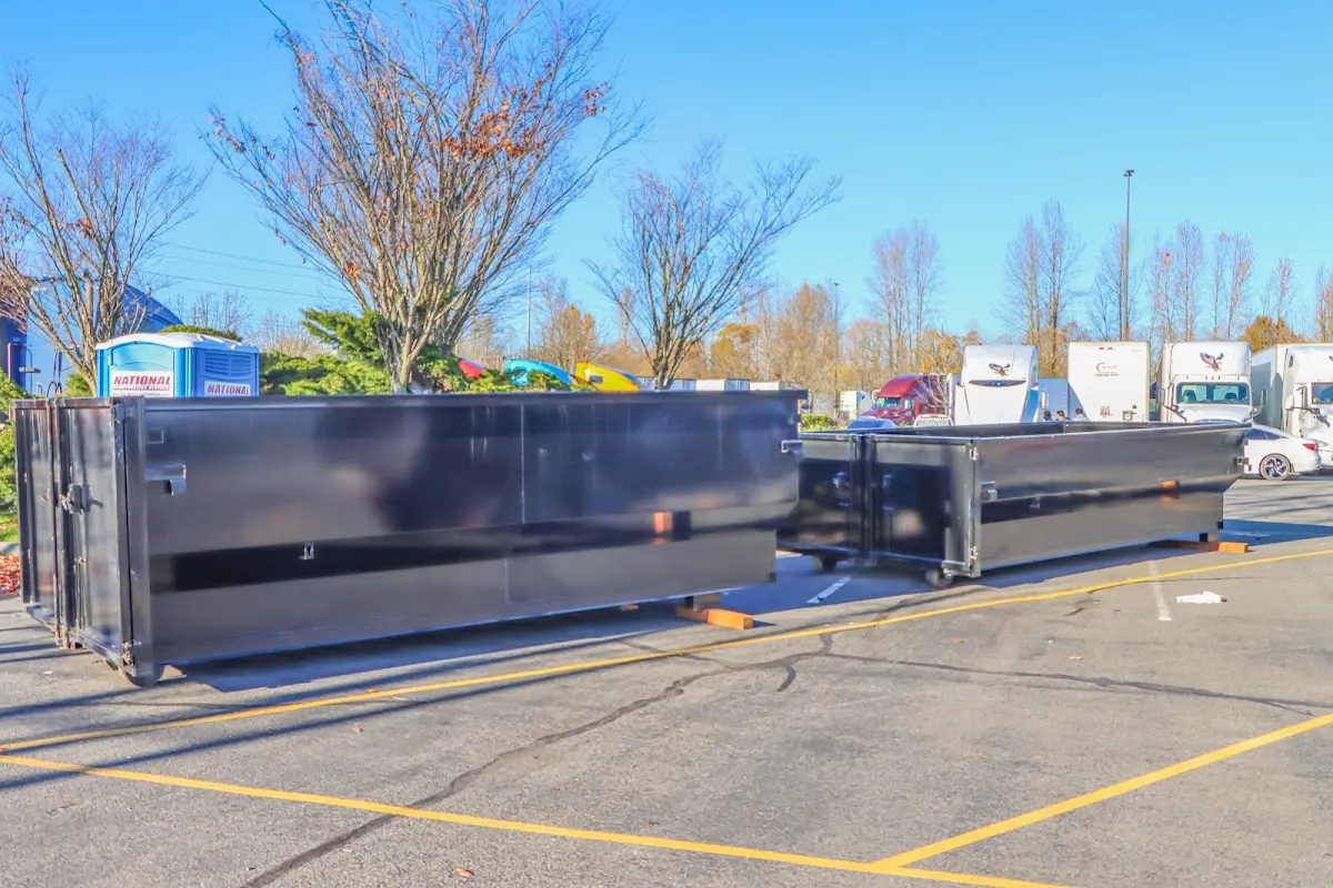 Professional dumpster rental service with roll-off container on residential driveway in Severn
